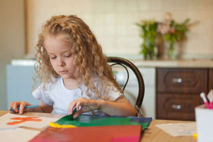 Girl doing craft while sitting at home
