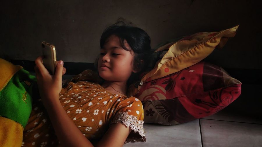 Little girl with cellphone in leisure time