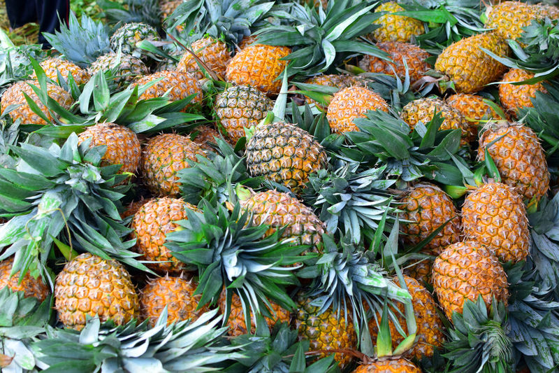 Full frame shot of fruits at market. healthy fruit pineapple and tropical fruits background.