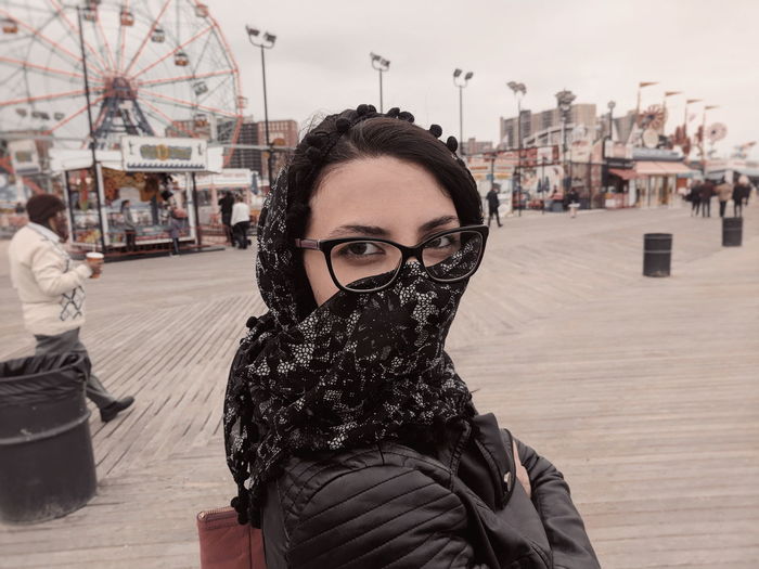 Portrait of woman wearing scarf at amusement park