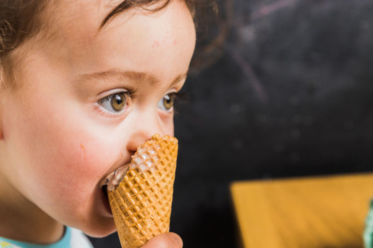 Close-up of young woman eating ice cream