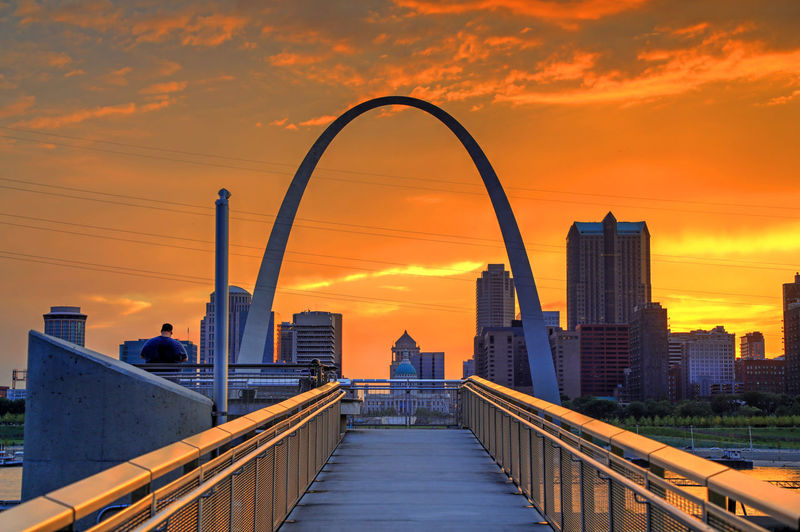 View of bridge and buildings against sky during sunset