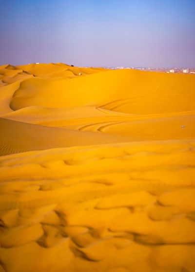 Scenic view of yellow desert against sky