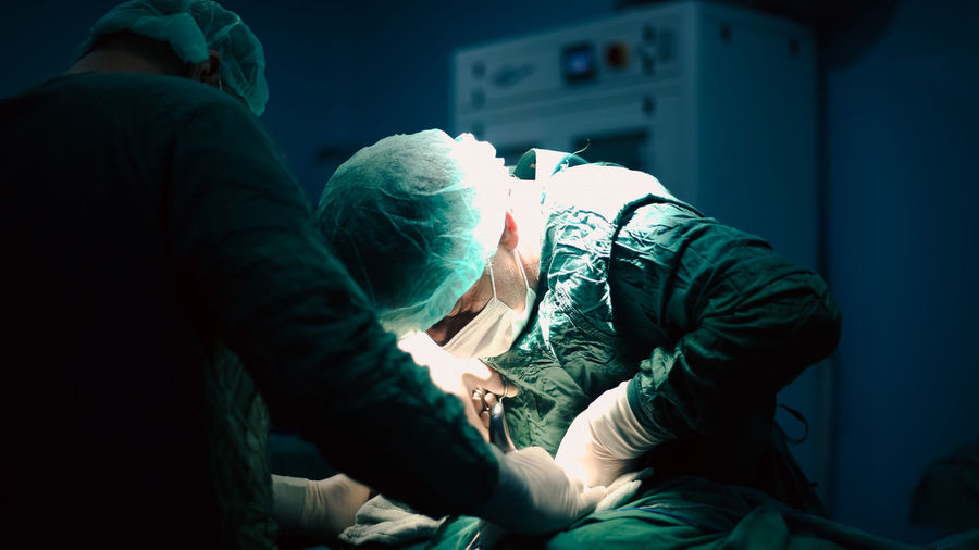 Doctors performing an appendectomy surgery, surgical concept.