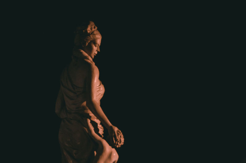 Statue against black background