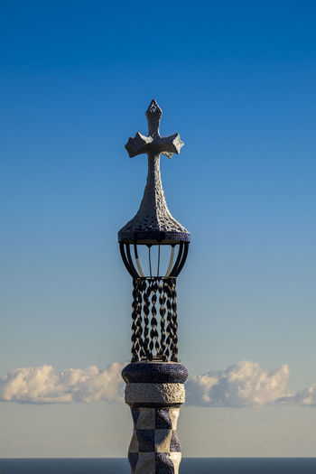 Cross on column against blue sky