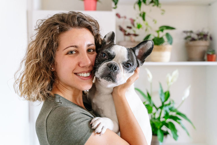 Portrait of a smiling young woman with dog