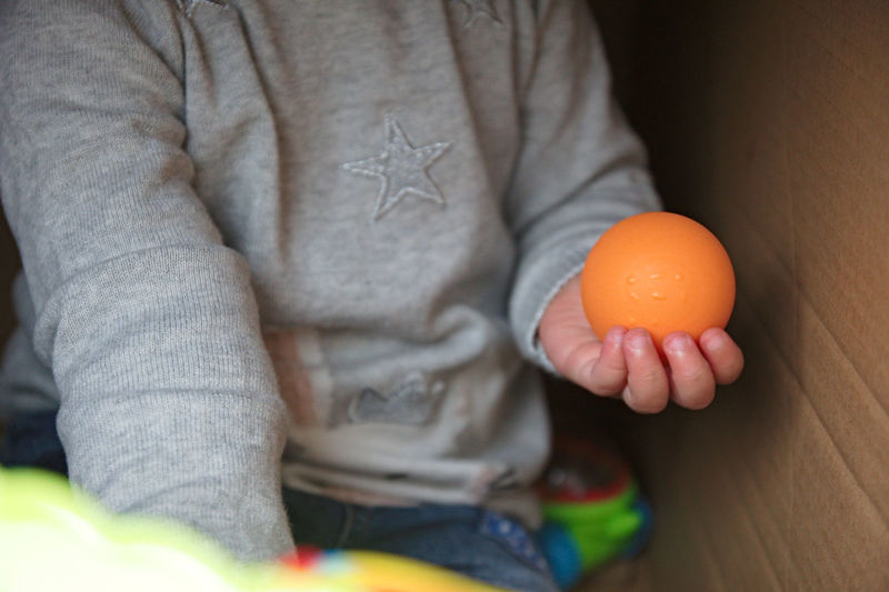Close-up of man holding orange juice