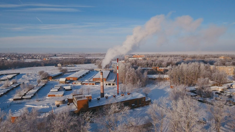 Boiler room in the winter season, from the chimneys rise up clouds of steam. 