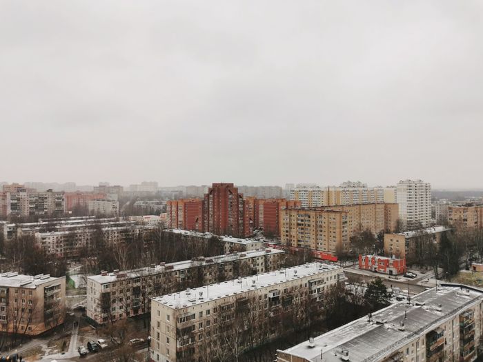 High angle view of buildings in city against sky