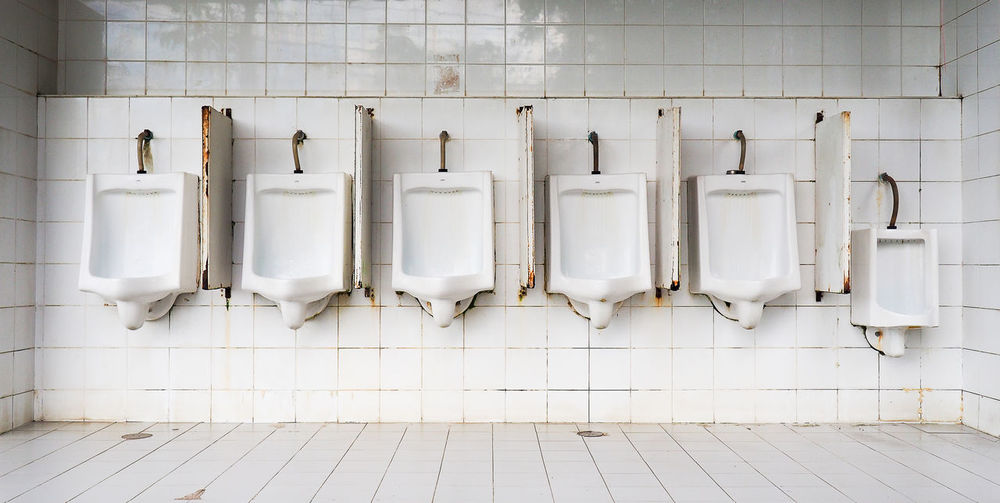 White urinals in public restroom