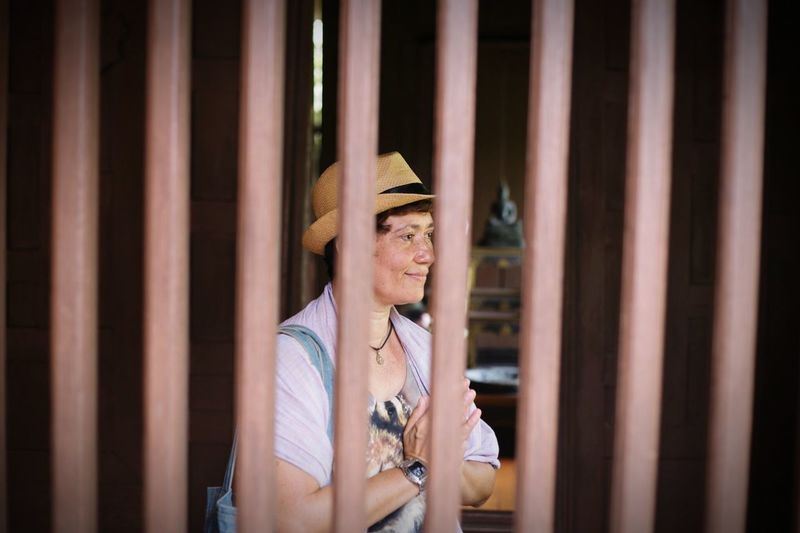 Smiling woman seen through railing