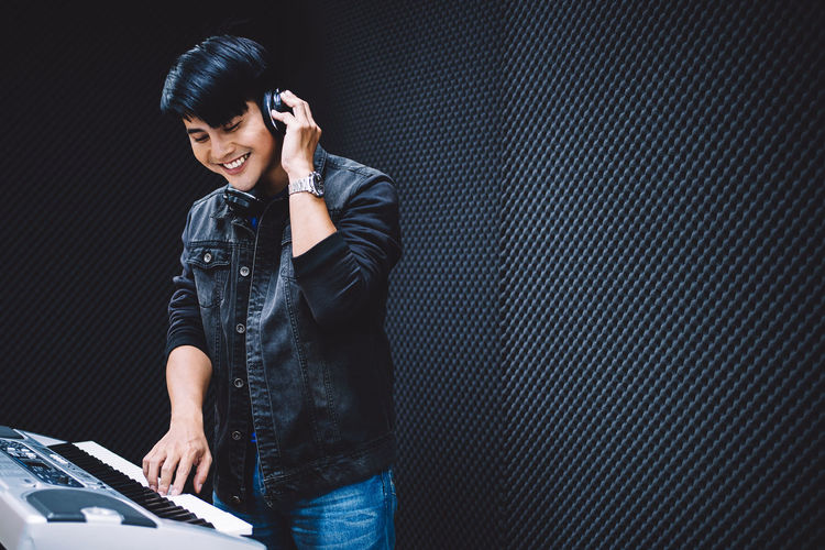 Smiling man playing keyboard