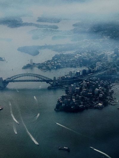 Aerial view of sydney harbor bridge over river during foggy weather