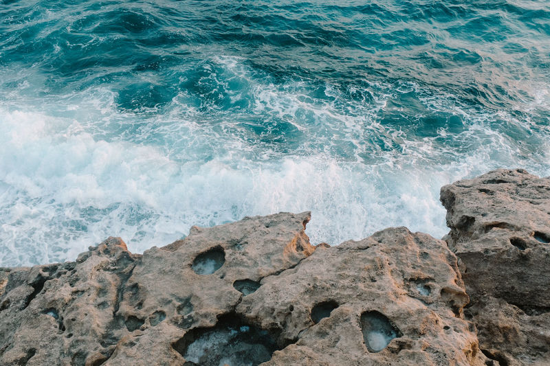 Blue sea waves on a rocky shore in cyprus