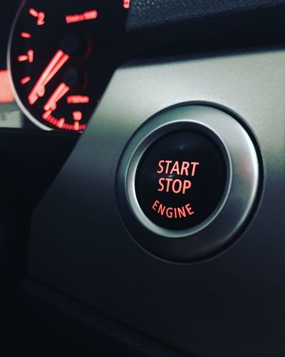 Close-up of illuminated text on push button in car