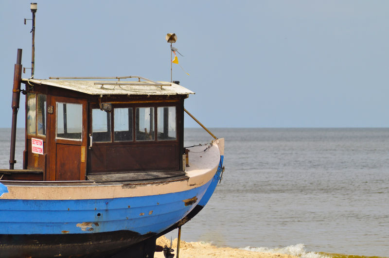 Boat on beach against clear sky