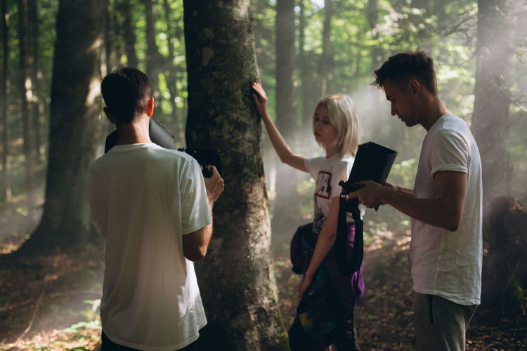 People with camera in the forest