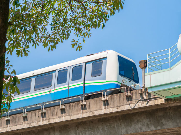 Low angle view of train against clear blue sky