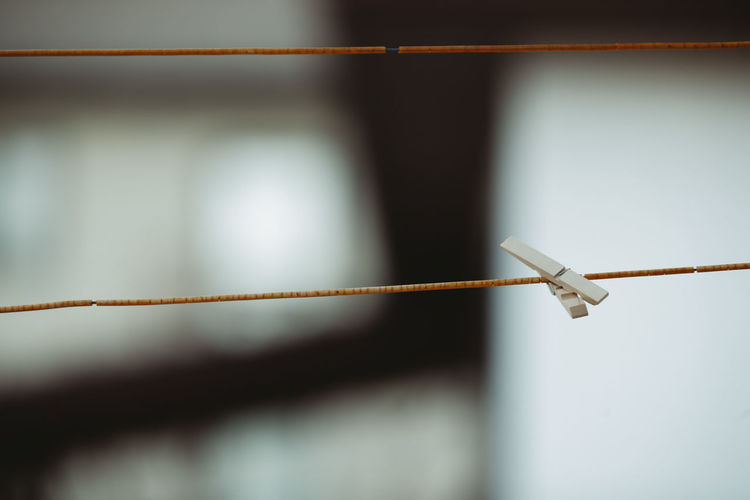 Close-up of rope tied on metal fence