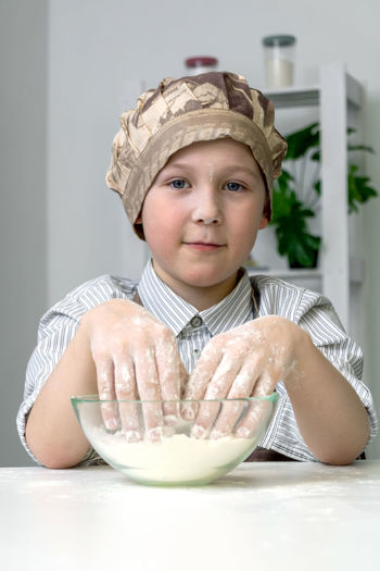 A child of 7-8 years old prepares dough for festive baking.