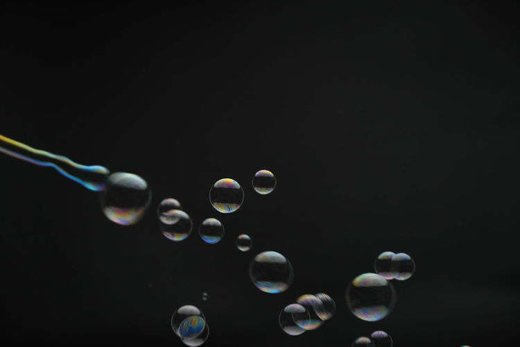 Close-up of bubbles against black background