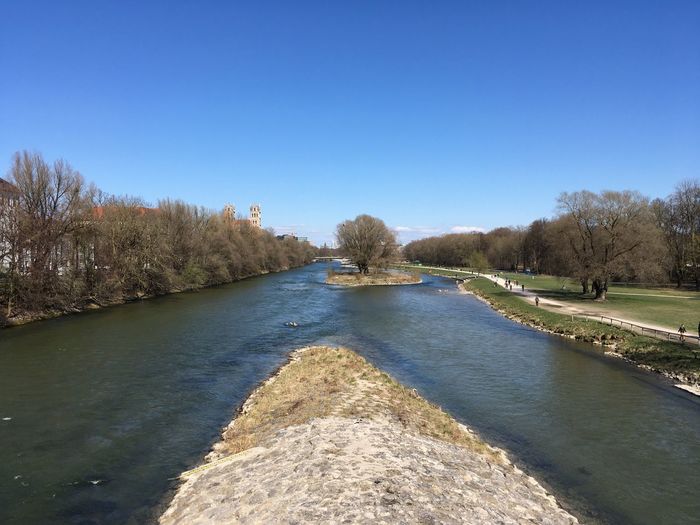 Scenic view of river against clear blue sky