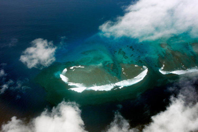 Aerial view of sea and clouds and coral reef
