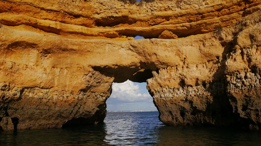 Boat trip through natural arch at ponta da piedale