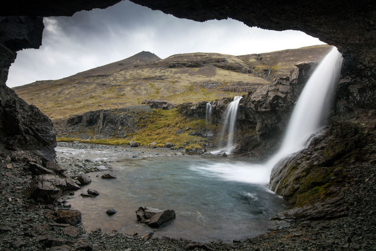Icelandic waterfall photographed from cave in mountains