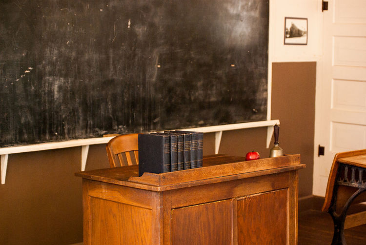 Teacher desk with books and apple
