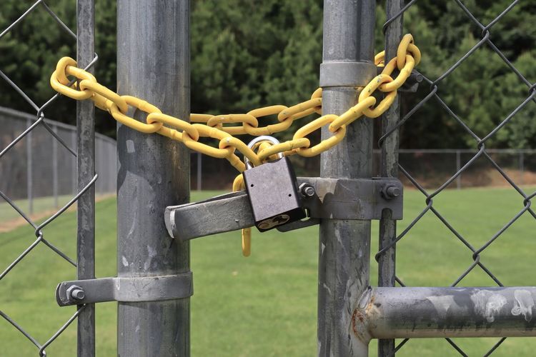 Close-up of padlock on fence