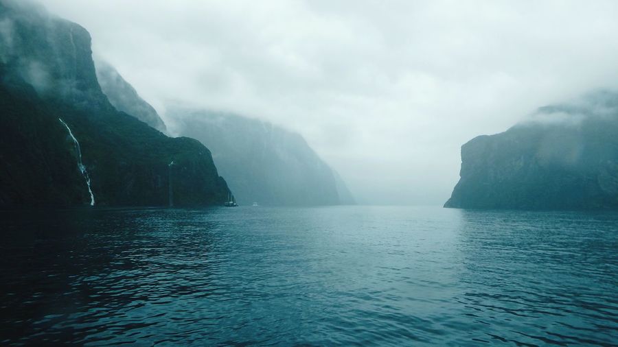 Scenic view of milford sound in foggy weather