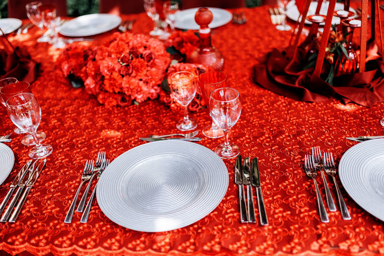 Silver set of dishes on a red tablecloth
