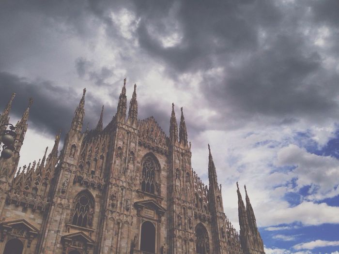 Low angle view of church against cloudy sky
