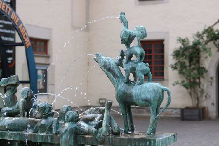 Statues at fountain in city