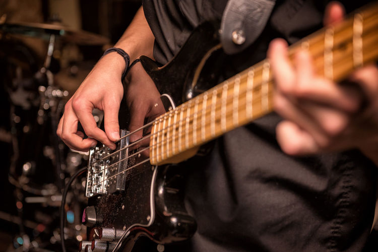 Cropped image of man holding guitar