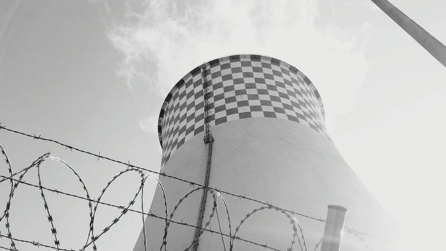 Low angle view of cooling tower against sky