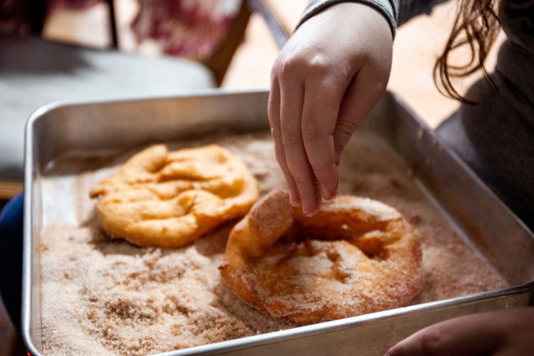 The preparation of a traditional food, sweet fritter called filhós from portugal. christmas time. 