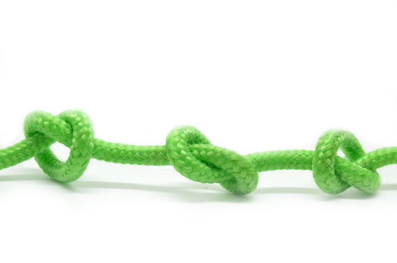 Close-up of rope over white background