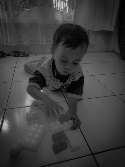High angle view of boy playing on floor at home