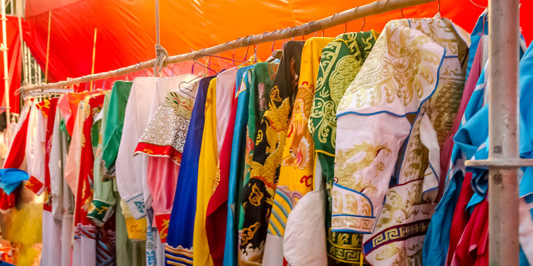 Close-up of costumes hanging on rack