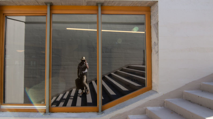 Man walking on staircase by window