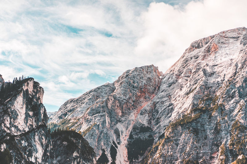 Low angle view of rocky mountains against sky