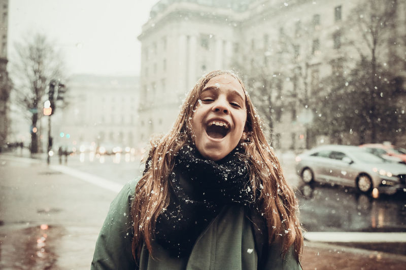 Portrait of smiling girl on street during winter