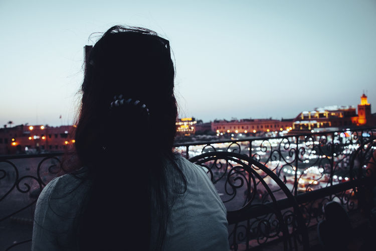 Rear view of man looking at cityscape