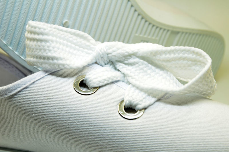 High angle view of white shoes on bed