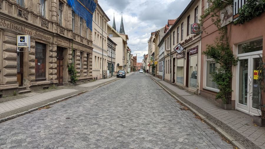 Narrow street amidst buildings in city