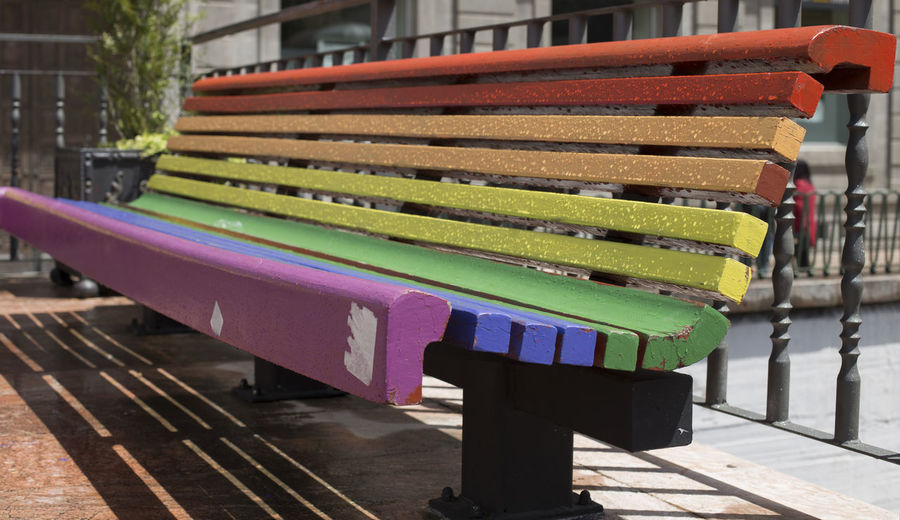 A rainbow painted bench in oviedo