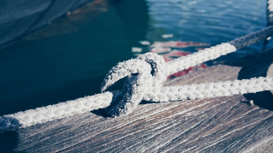 Close-up of tied rope on boat at harbor